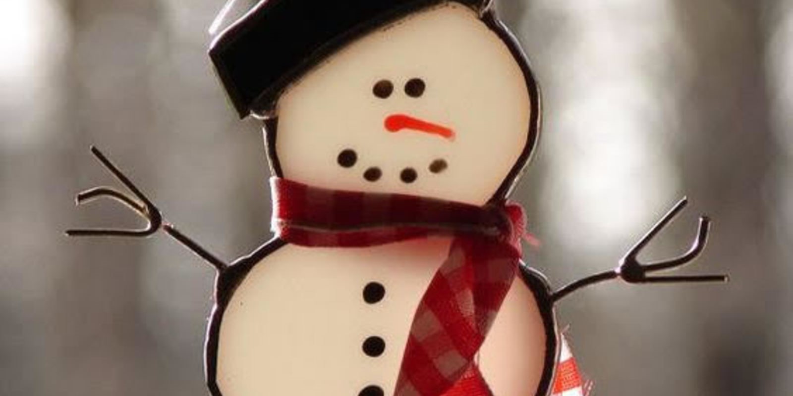 Snowman with a plaid scarf and blakc hat
